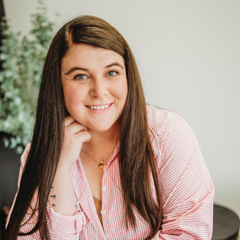 person smiling at a camera with white background