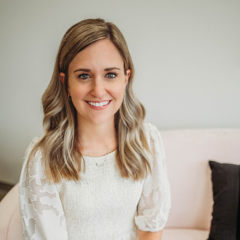 Woman resting her face on her hand while smiling