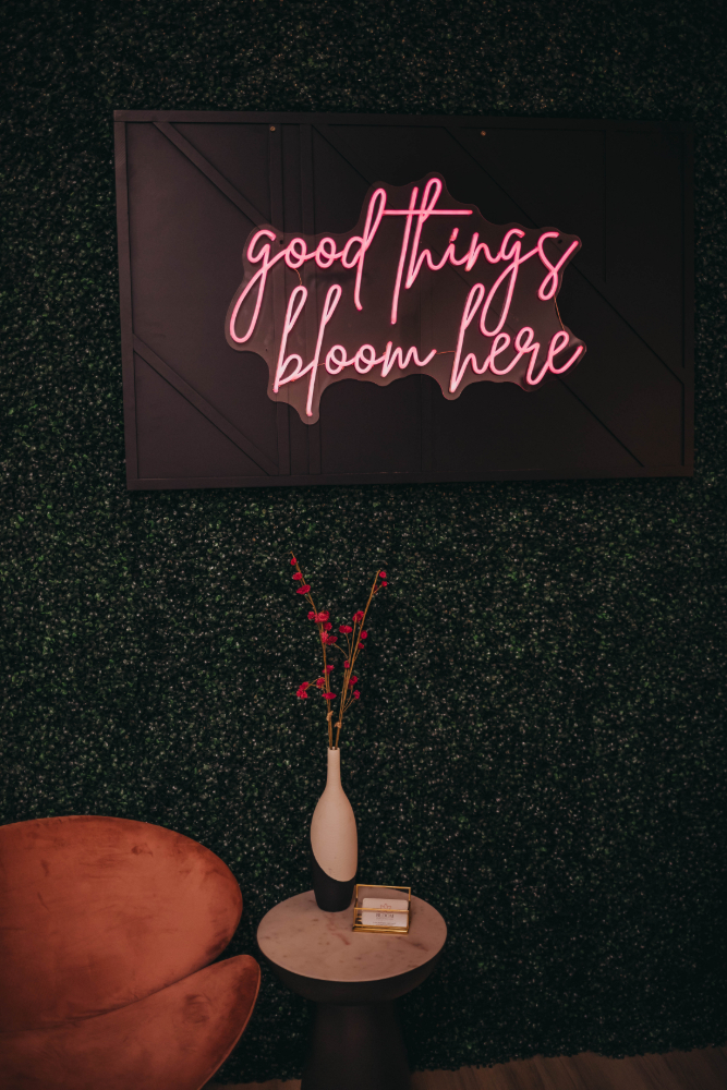 Off white and pink colored waiting room with a gold lamp.