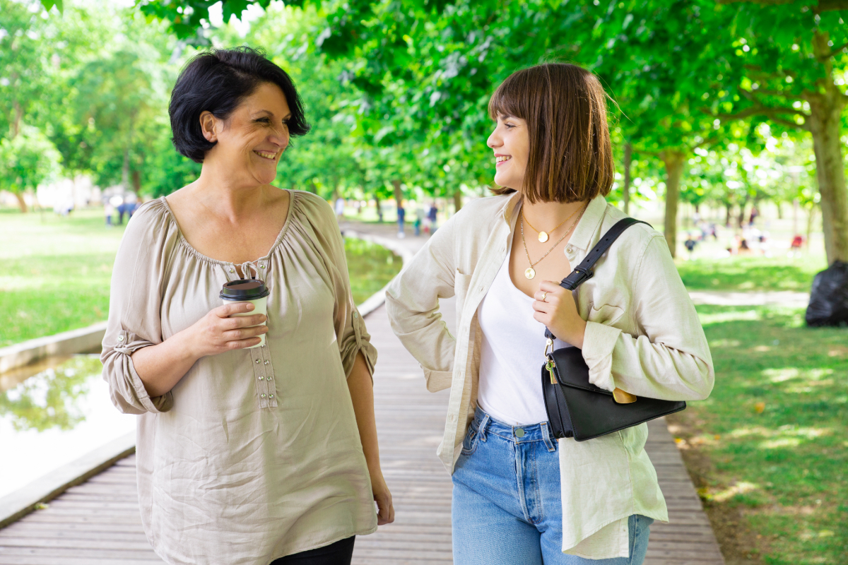 Two women talking and walking outside.