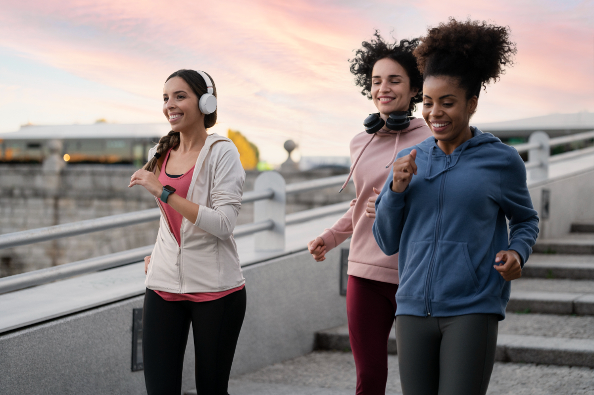 Three women jogging outside.